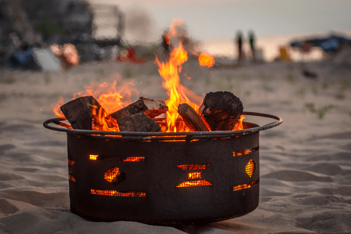A warm bonfire lit on a sandy beach
