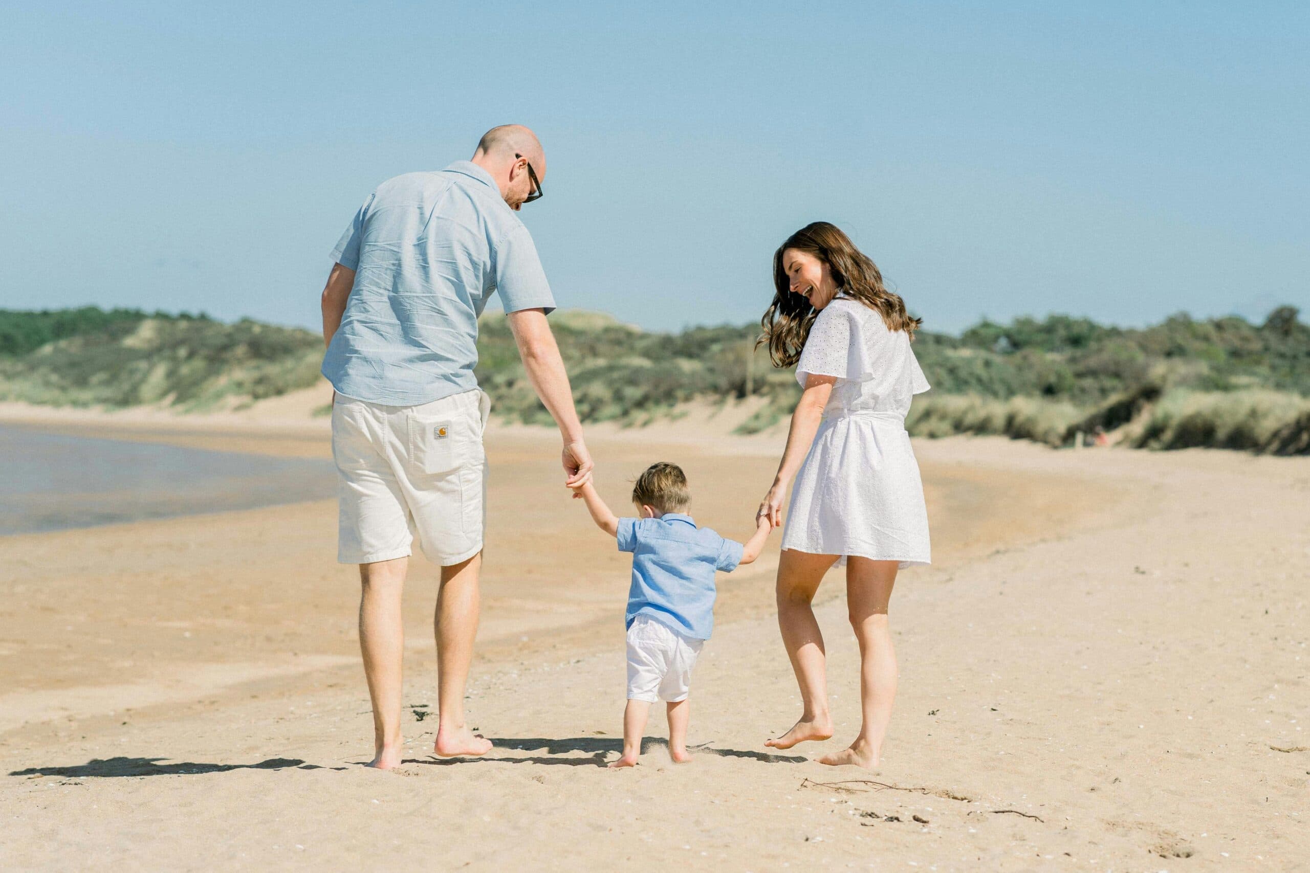 A happy family walking on the beach