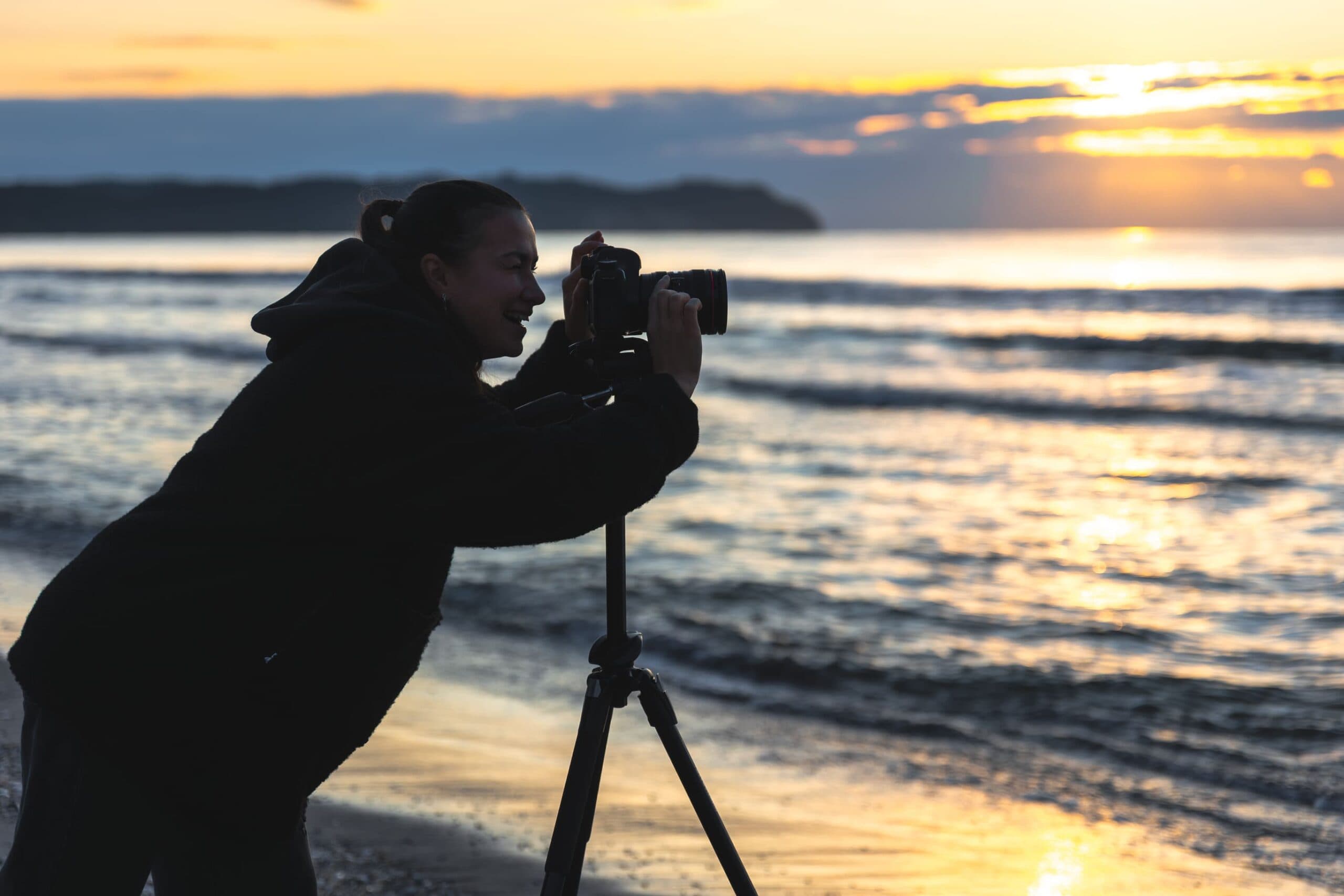 A photographer captures the sunset at sea