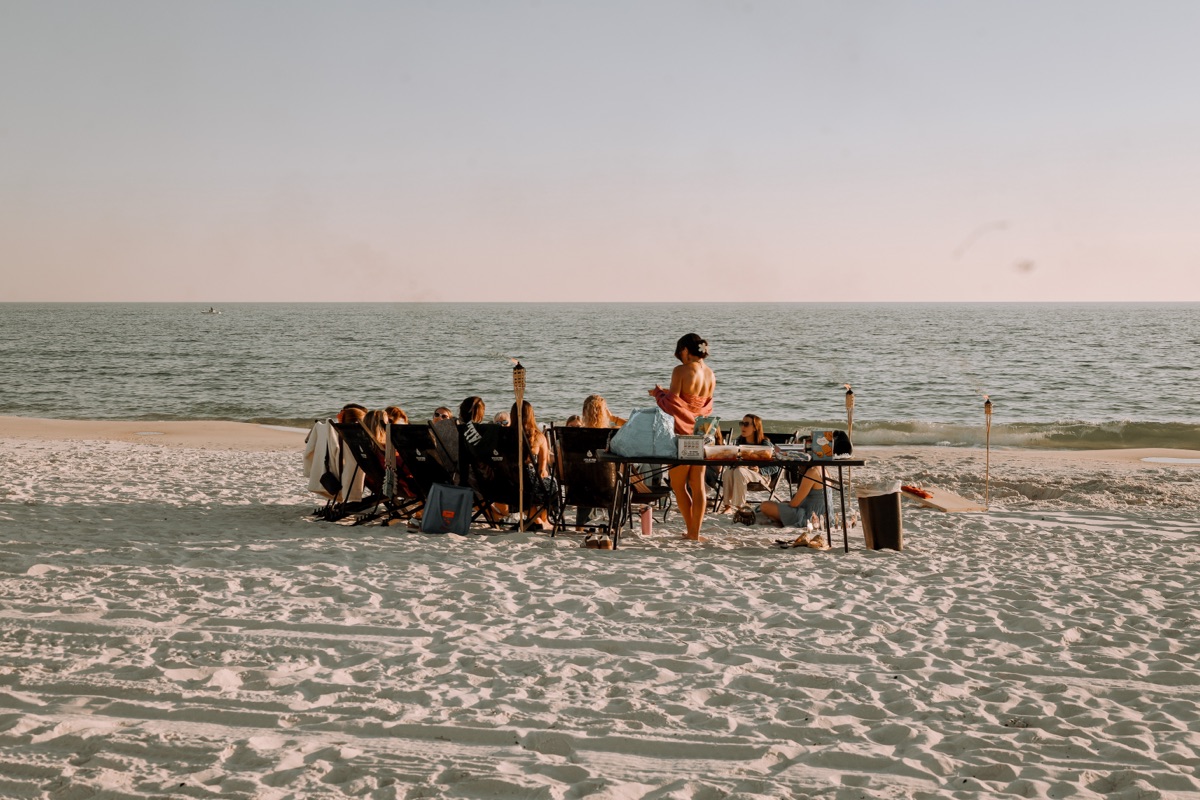 Romantic beach bonfire proposal setup