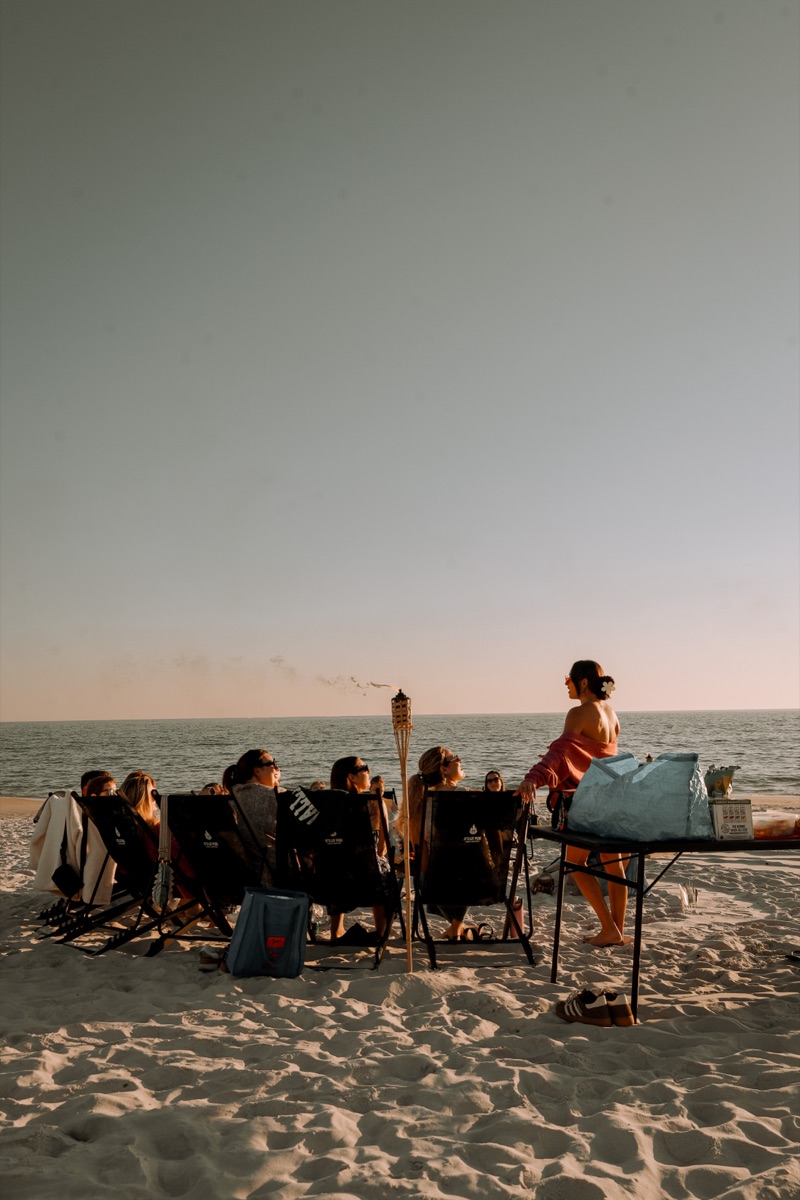 Friends enjoying girls trip beach bonfire